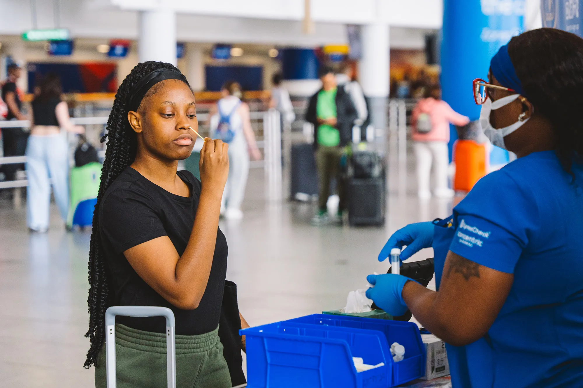 Female Swabs her nose at the airport to test for viruses